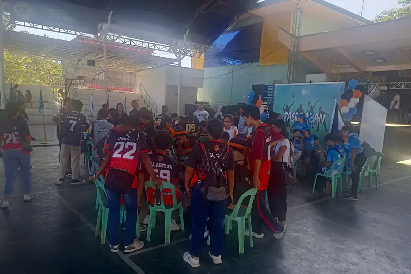 Teams in jerseys gathered at a covered-court Mobile Legends tournament in the Philippines